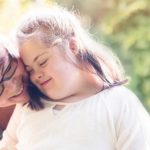 Portrait of nurse with her patient of 12 years old with Down Syndrome